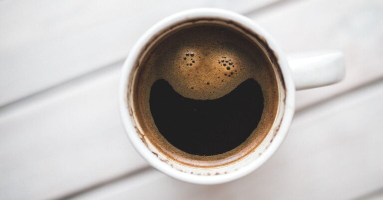 coffee with a happy face from foam emphasizing with the title of the post: "Mood Shifting Actions That Improve Your Mood and Energy"